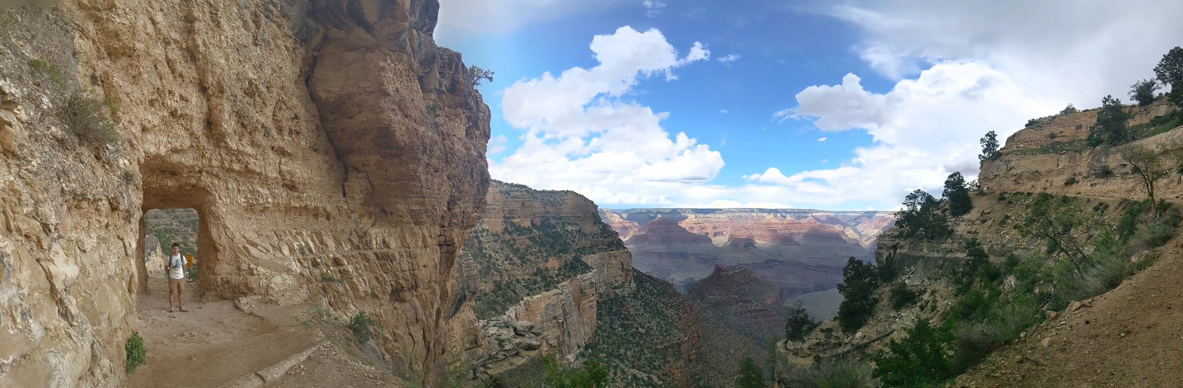 Panorama of a deep canyon from a cliffside trail
