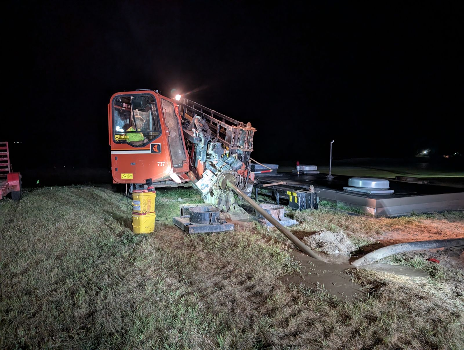 Directional drill rig working under lights at night